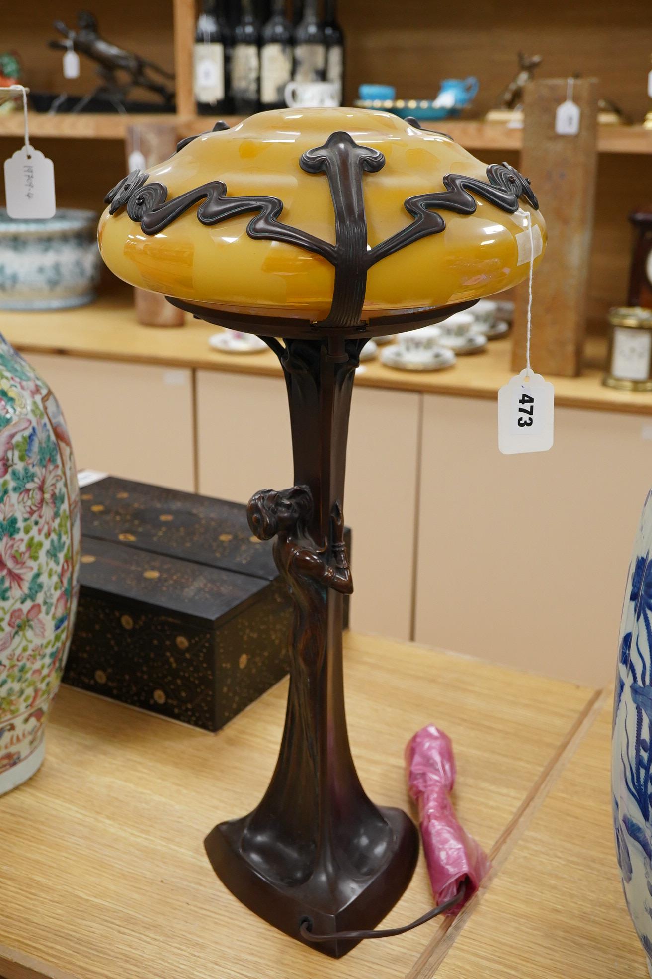 In the manner of Gustav Gurschner, an Art Nouveau style figural bronze lamp with yellow etched shade, 58cm